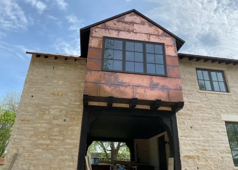 Copper metal panel facade on a stone building for Skylight Installation in Westwood Lakes